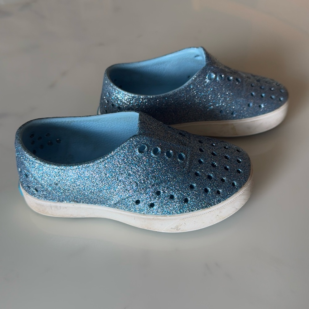 Native blue sparkle slip on sneakers